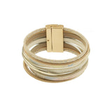 The Origin Light Matte Gold & White Magnetic Bracelet features overlapping gold and silver bands with a rectangular gold clasp, offering an elegant touch of sophistication to any outfit.