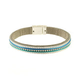 The Origin Matte Silver, Blue & Aqua Bead Center Magnetic Bracelet features elegant silver, turquoise, and blue beads in parallel rows with a silver clasp—an eye-catching accessory for any occasion.