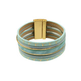The Origin Light Matte KC Gold & Aqua Magnetic Bracelet features wide, multi-strand aqua faux leather bands with KC gold accents, a rectangular gold clasp, and repeating gold whale tail patterns.