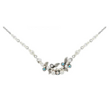 The Petite Flora W/ Glass Pearls White Necklace by Firefly is a delicate piece of handmade jewelry featuring silver leaves, small white glass pearls, and blue gemstones on a thin silver chain.