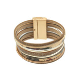 The Matte Gold/Shiny Gold Magnetic Bracelet by Origin features multi-layered silver, matte gold, and shiny gold bands with textured and glitter details, plus a magnetic clasp for easy wear. This elegant bracelet offers a stacked, stylish look.