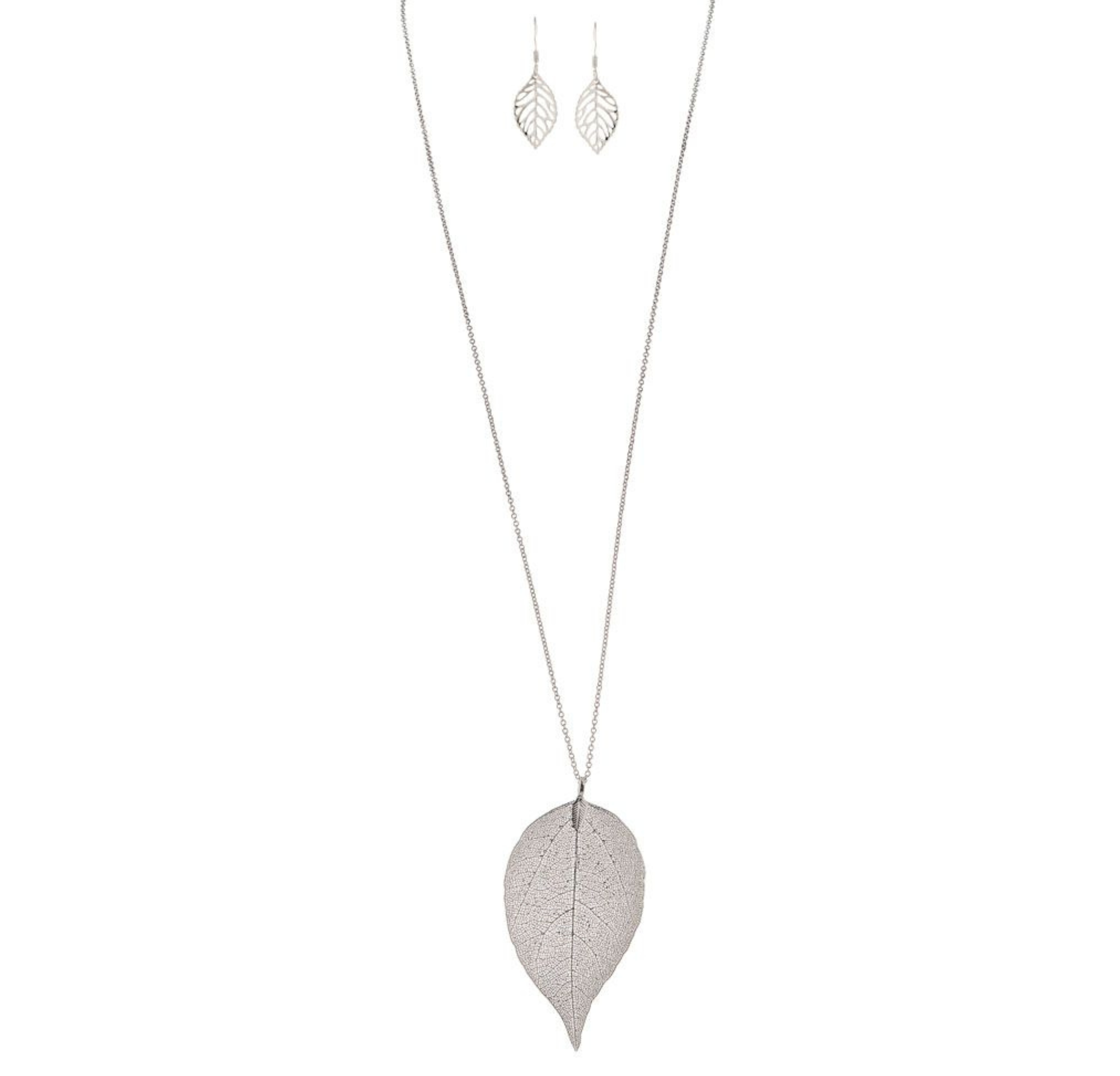 The A-Train Silver Long Large Natural Leaf Necklace Set features a detailed leaf-shaped pendant on a long necklace, with matching earrings, crafted from high-quality mixed metals and shown on a white background.