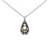 Adorn yourself with the Teardrop Glass Pearl Pendant White Necklace by Firefly, featuring a delicate silver chain and a teardrop-shaped pendant with a central white glass pearl accented by smaller border stones in an ornate, vintage-inspired setting. Handmade with Firefly’s signature craftsmanship, this elegant necklace is perfect for those who appreciate unique and timeless accessories.