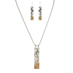 The A-Train Multi Metal Dragonfly Landscape Necklace Set features matching necklace and earrings with rectangular silver-tone pendants, etched with a nature-inspired design and accented with gold and copper details.