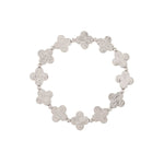 The A-Train Silver Line Etched Clovers Stretch Bracelet showcases textured four-petal links and small beads, crafted from premium mixed jeweler’s metals in a charming circular design.