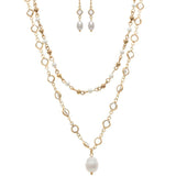 The A-Train Gold Mix Faux Pearl Crystal Necklace Set includes a layered gold-tone necklace with a large pearl pendant and matching drop earrings detailed with white pearls and small crystals.
