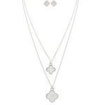 Explore the A-Train Silver White Layered Clover Necklace Set, featuring a stylish layered necklace and matching clover stud earrings crafted from mixed jeweler’s metals, all on a sleek white background.
