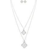 Explore the A-Train Silver White Layered Clover Necklace Set, featuring a stylish layered necklace and matching clover stud earrings crafted from mixed jeweler’s metals, all on a sleek white background.