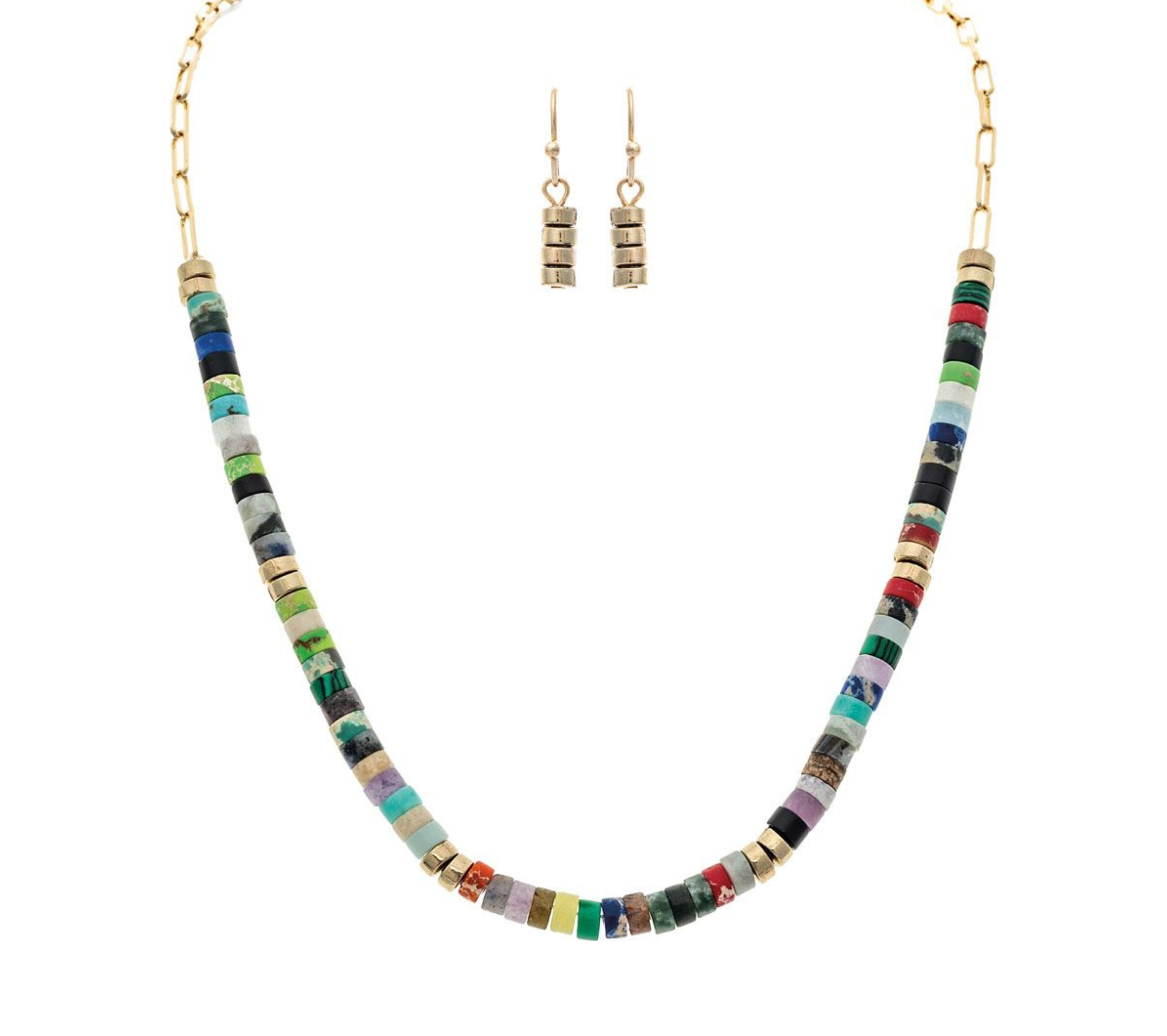 The A-Train Gold Multi Stone Disc Beads Necklace Set features a vibrant necklace with colorful stacked disc beads and gold accents, plus matching dangle earrings with three stacked gold beads for a coordinated style.