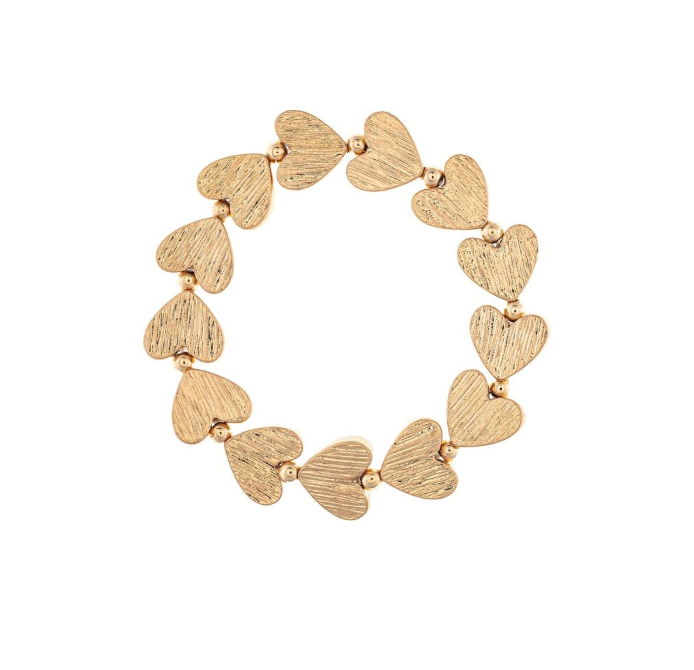 The A-Train Gold Line Etched Hearts Stretch Bracelet features textured gold heart-shaped charms and small beads, crafted from mixed jeweler’s metals for versatile style perfect for any occasion.