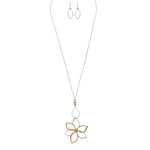 The A-Train Two-Toned Big Flower Long Necklace Set includes a long silver chain with an openwork flower pendant in gold and silver tones, crafted from mixed jeweler’s metals, and comes with matching drop earrings.