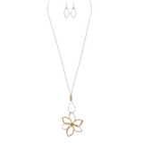 The A-Train Two-Toned Big Flower Long Necklace Set includes a long silver chain with an openwork flower pendant in gold and silver tones, crafted from mixed jeweler’s metals, and comes with matching drop earrings.