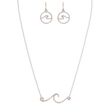 The A-Train Silver Rip Curl Wave Necklace Set includes a delicate necklace with a wave-shaped pendant and matching circular wave earrings, all displayed on a white background.