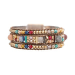 The A-Train Gold Multicolor Bead Cord Woven Bead Magnetic Bracelet features vibrant rows of colorful and gold-tone beads on brown cord, adding a lively accent to any outfit.