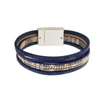 The Origin Matte Silver, Navy & Crystals Magnetic Bracelet features navy faux leather bands, gold accents, clear rhinestones, and a rectangular silver magnetic clasp.
