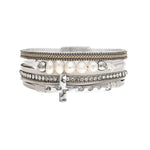 The A-Train Silver White Pearl Crystal Side Cross Magnetic Bracelet features silver bands, white pearls, crystal accents, and a side cross charm in a stylish stacked design.