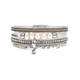 The A-Train Silver White Pearl Crystal Side Cross Magnetic Bracelet features silver bands, white pearls, crystal accents, and a side cross charm in a stylish stacked design.