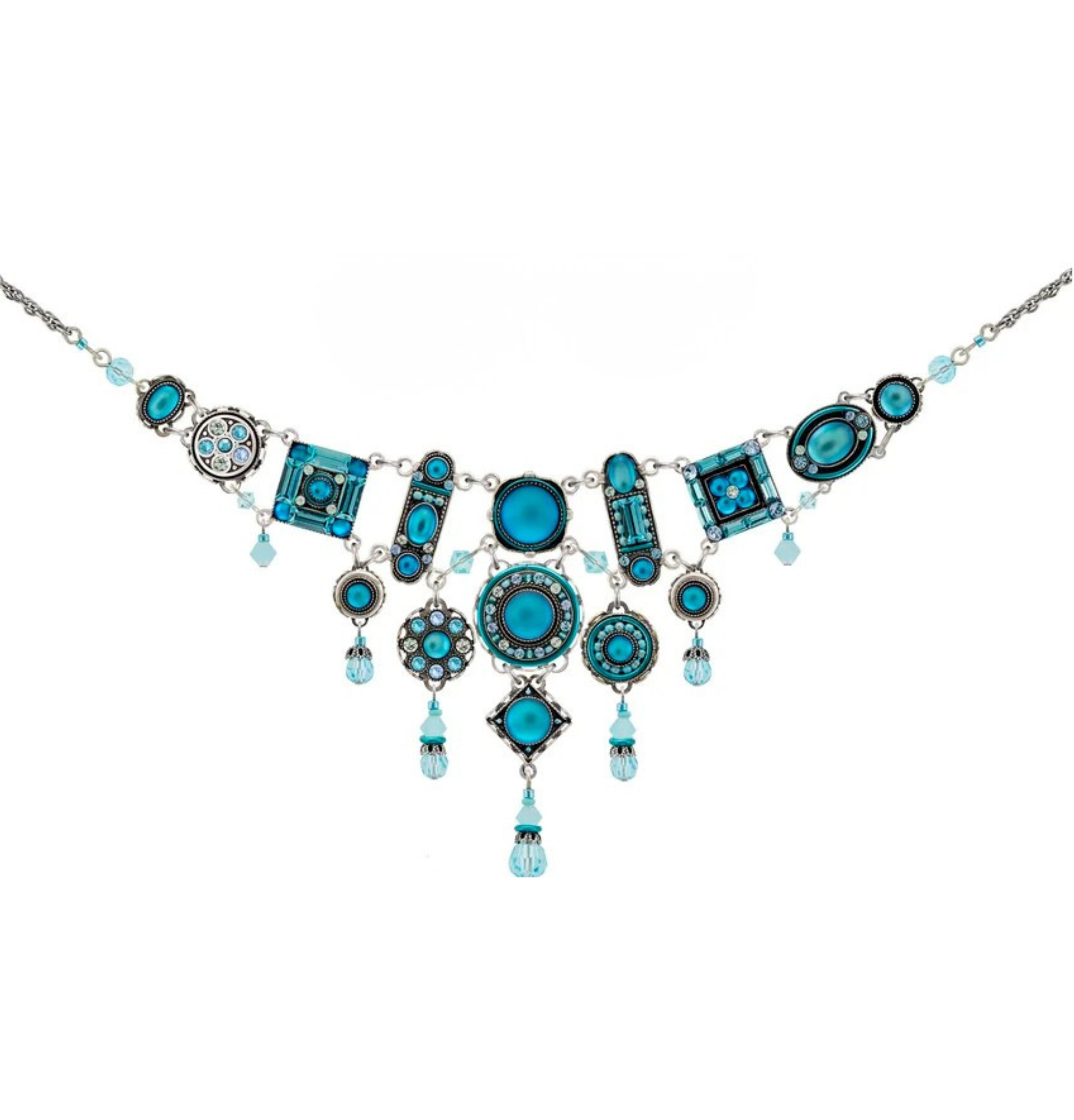 The La Dolce Vita Bib Moonlight Light Blue Necklace by Firefly features blue circular and rectangular pendants accented with dangling blue beads in an ornate, symmetrical design; this fair-trade artisan piece is a beautiful example of handmade jewelry from Guatemala.