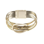 The Origin Shiny Gold Strand/Silver Circle Focal Magnetic Bracelet features shiny gold strands, silver metal bands, a rectangular clasp, and a bold silver circle centerpiece.