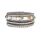 The A-Train Silver Gray Crystal Shell Leaves Magnetic Bracelet features braided and metallic bands, sparkling beads, and cream and tan leaf accents, blending textures and patterns in silver, gray, gold, and neutral tones.