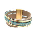 Origins Matte Gold & Aqua Print Magnetic Bracelet features matte gold, turquoise, and beige bands with gold accents and a rectangular gold clasp, shown on a white background.