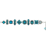The La Dolce Vita Moonlight Light Blue Bracelet by Firefly is a stunning silver piece adorned with an array of light blue and turquoise geometric gems—circles, squares, rectangles, and ovals—each arranged in a harmonious repeating pattern. Handmade and thoughtfully crafted as fair-trade jewelry, this bracelet beautifully captures the elegance of artisan Firefly design.