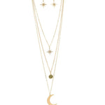The A-Train Gold Three Layer Moon/Star Necklace Set features star-shaped earrings and a layered necklace with starburst, green stone, and crescent moon pendants for a chic, versatile look.