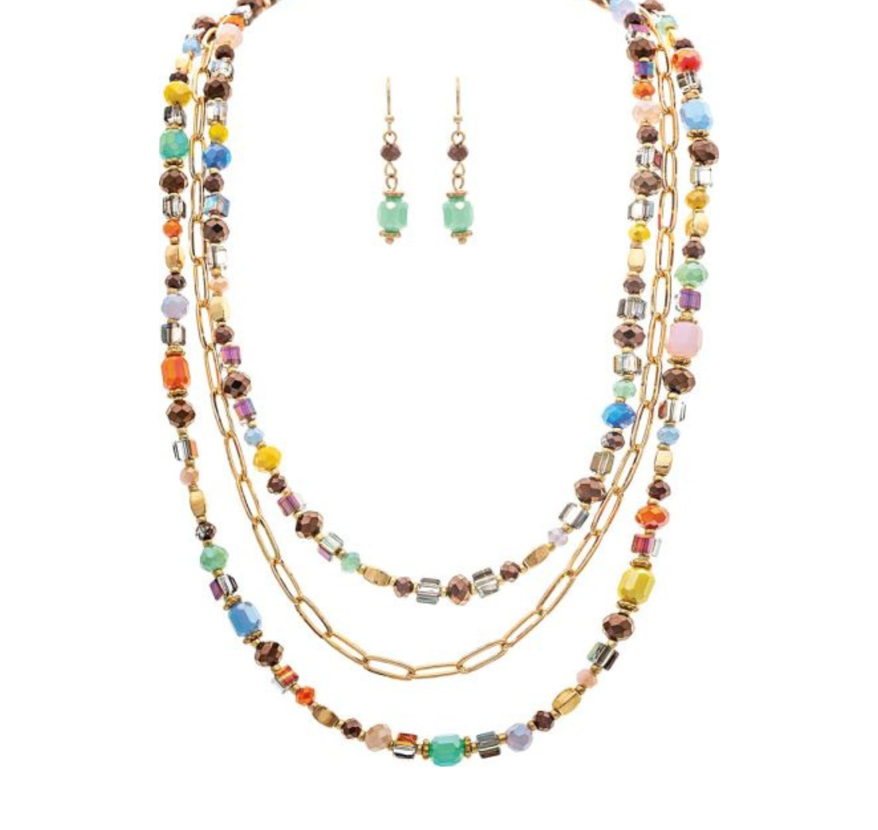 The A-Train Gold Multicolor Faceted Square Beads Layer Necklace Set features high-quality mixed metal craftsmanship and includes matching green beaded dangle earrings for a coordinated look.