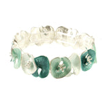 The Origin Matte Silver & Aqua Lily Pad Bracelet features alternating teal and white enamel flower-shaped links with matte silver stamens, arranged in a charming circular pattern for versatile style.