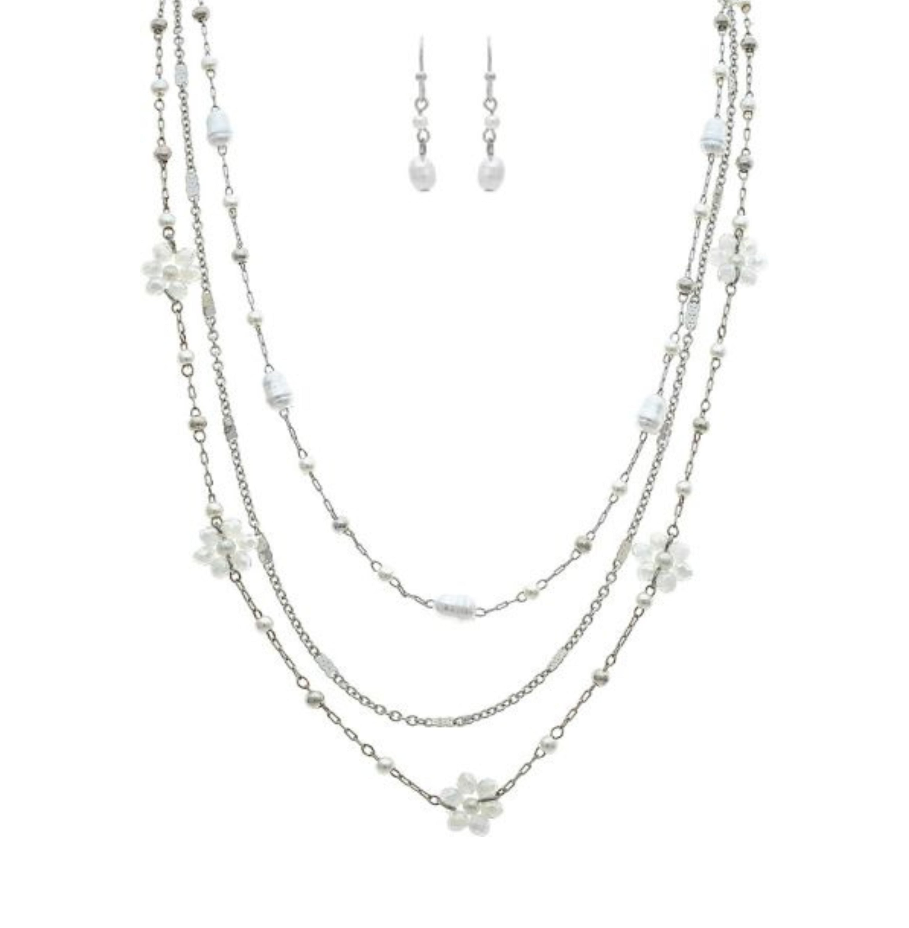 The A-Train Silver White Flowers Beads Chain Layer Necklace Set features a three-tiered necklace with delicate white beads, flower accents, and matching dangling earrings.