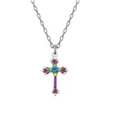 Introducing the Dainty Cross Sapphire Necklace by Firefly, a stunning piece of handmade jewelry featuring a silver chain necklace with a cross pendant adorned with blue, green, and pink gemstones arranged in an elegant decorative pattern.