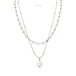 The A-Train Silver Layer Chain FWP Coin Drop Necklace Set features layered silver chains, a round pearl pendant, and matching pearl earrings, all displayed on a white background for an elegant look.
