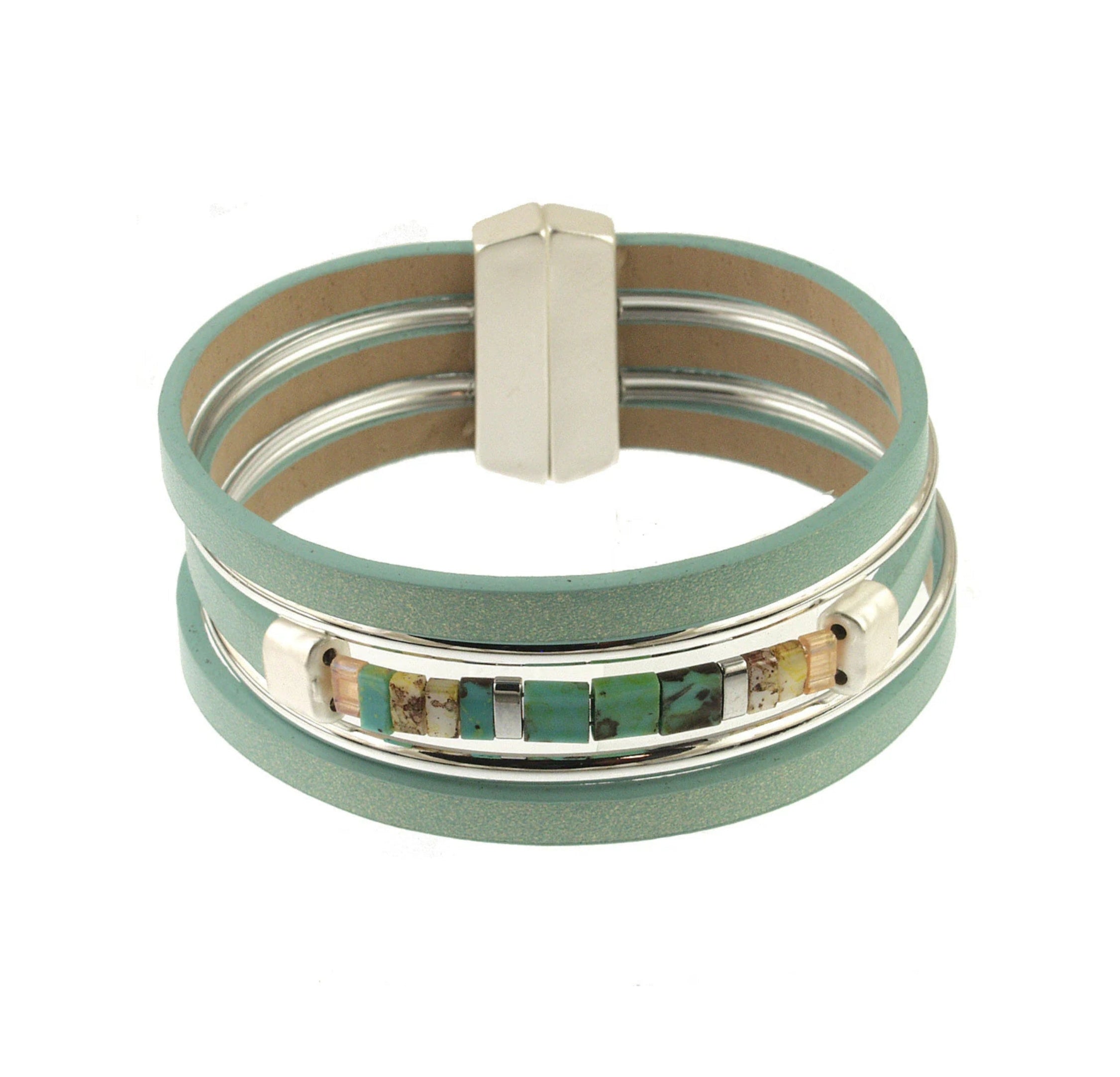 The Origin Matte Silver & Aqua Magnetic Bracelet features three teal leather bands, a silver clasp, and a central row of turquoise glass beads with metallic cube and matte silver accents.