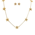 The A-Train Gold Tiny Flower Chain Necklace Set features a necklace with evenly spaced flower charms and matching gold flower stud earrings, crafted from mixed jewelers metals, shown on a white background—perfect for daily chic style.