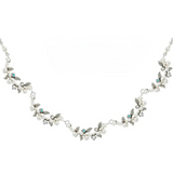 Introducing the Flora w/Glass Pearls White Necklace by Firefly—a delicate silver necklace adorned with leaf accents, shimmering glass pearls, sparkling crystals, and petite turquoise-tone stones. Handmade by Firefly Jewelry, this piece beautifully captures nature’s elegance in a graceful, nature-inspired design.