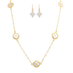 The A-Train Gold Mother-of-Pearl Clovers Necklace Set features a delicate chain with white four-leaf clover charms and matching earrings—perfect jewelry for special occasions, shown on a white background.