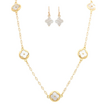 The A-Train Gold Mother-of-Pearl Clovers Necklace Set features a delicate chain with white four-leaf clover charms and matching earrings—perfect jewelry for special occasions, shown on a white background.
