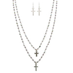 The A-Train Silver Faux Pearl Cross Charm Layered Necklace Set features three silver beaded chain necklaces of varying lengths with cross charms, plus matching drop earrings, all displayed on a white background.