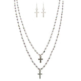 The A-Train Silver Faux Pearl Cross Charm Layered Necklace Set features three silver beaded chain necklaces of varying lengths with cross charms, plus matching drop earrings, all displayed on a white background.