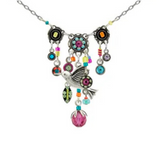 Adorned with a bird pendant, vibrant beads, circular charms, and a prominent pink gemstone at its center, the Hummingbird Waterfall Multi-Color Necklace by Firefly is a breathtaking example of handmade jewelry. This piece highlights the artistry of fair-trade craftsmanship, making it both beautiful and ethically created.