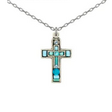 Introducing the Moonlight Petite Cross Light Blue Necklace by Firefly. This elegant silver chain necklace features a cross pendant adorned with turquoise and blue stones in a variety of shapes and sizes. Reflecting the intricate craftsmanship of handmade jewelry, this Firefly piece is a distinctive and refined addition to any collection.