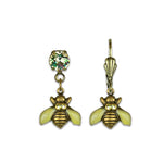 The Tiny Enamel/Stone Bee Earrings by Anne Koplik Designs, Inc. feature hand-enameled, antiqued brass bees with sparkling gem accents—one with a clear stone above the bee and the other on a gold hook.
