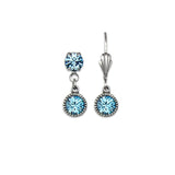 The Simple Drop Aqua Earrings by Anne Koplik Designs, Inc. are timeless silver earrings, each with two round blue stones—a small top gem and a larger dangling gem set in delicate beads.