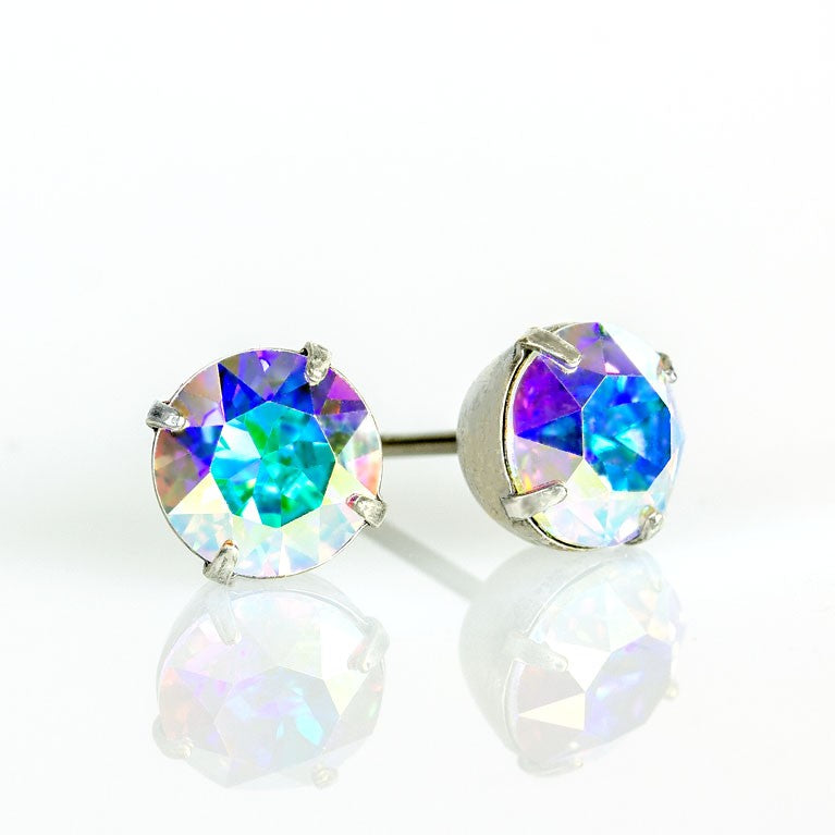 The Simple Post Crystal Earrings by Anne Koplik Designs, Inc. feature radiant round crystals in silver prongs, shimmering with blue, green, and purple hues—ideal for bridesmaid jewelry.