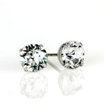 Anne Koplik Designs, Inc. Simple Post Crystal Earrings feature round, faceted crystals in a four-prong white metal setting—an elegant choice for bridesmaid jewelry, shown on a white reflective surface.
