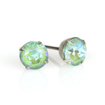 The Simple Post Silky Sage Delite Earrings by Anne Koplik Designs, Inc. feature round green-blue gemstones in sterling silver plated prongs, perfect for bridesmaids jewelry and beautifully displayed on a reflective white surface.