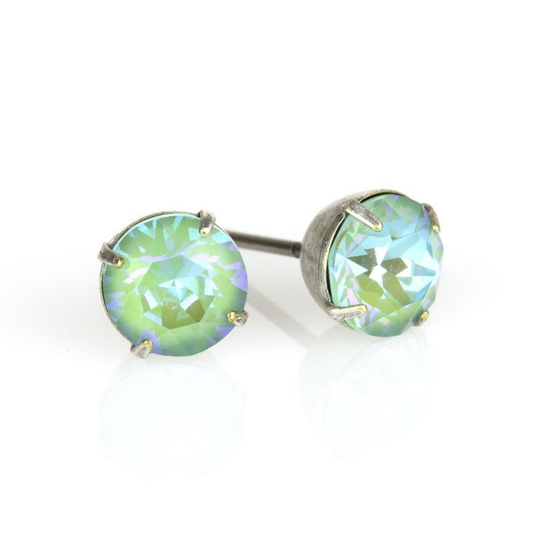 The Simple Post Silky Sage Delite Earrings by Anne Koplik Designs, Inc. feature round green-blue gemstones in sterling silver plated prongs, perfect for bridesmaids jewelry and beautifully displayed on a reflective white surface.