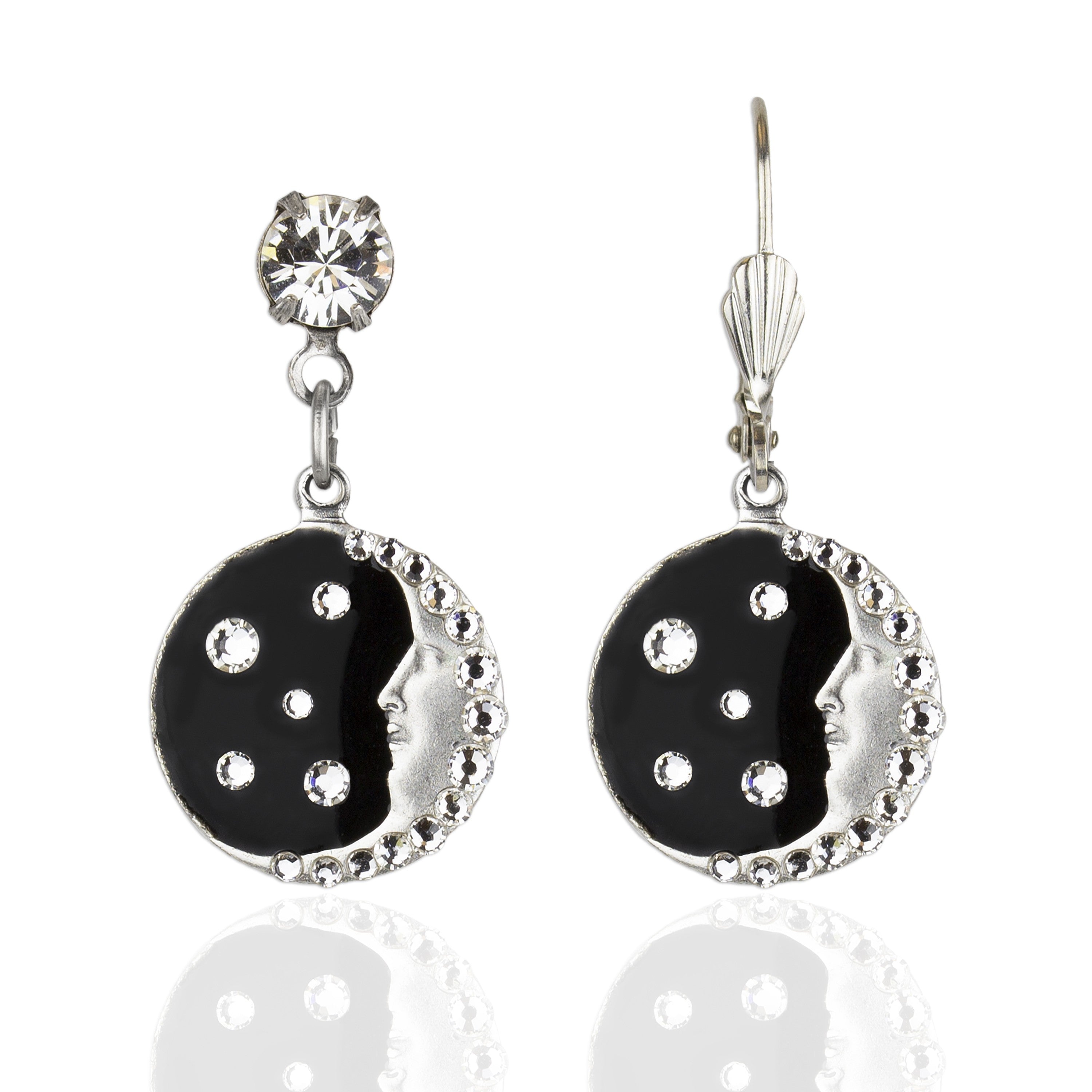 The Man in the Moon Black Background/Enamel & Stone Earrings by Anne Koplik Designs, Inc. feature a silver-plated moon face with black enamel, clear crystal accents, and a round gemstone detail.