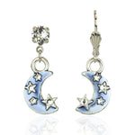 The Dream Stone/Enamel Blue Moon Earrings by Anne Koplik Designs, Inc. feature silver-plated crescent moons with clear gemstone studs, dangling moon charms adorned with small stars, and light blue hand-enameled accents.