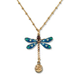 The Enamel & Stone Teal Dragonfly/Amber Drop Necklace by Anne Koplik Designs, Inc. features a gold chain, blue-winged dragonfly pendant with green, white, and brown gems, and an amber drop—perfect for artisanal teal jewelry lovers.
